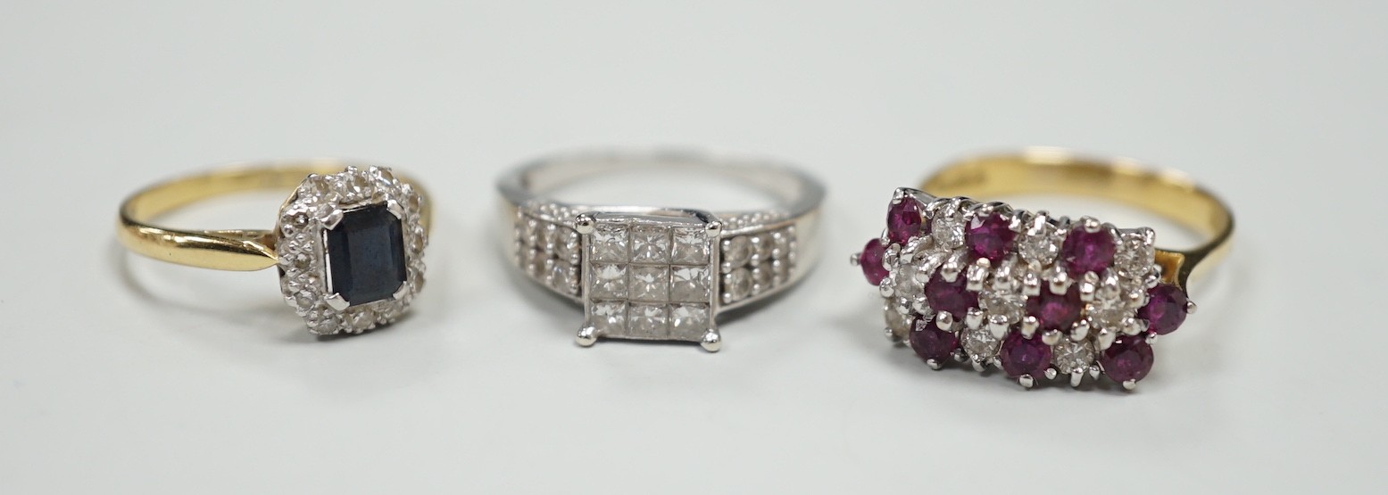 Three assorted modern gem set rings, including white metal and diamond cluster tablet ring with diamond set shoulders, an 18ct gold, sapphire and diamond cluster set ring and an 18ct gold ruby and diamond set cluster rin